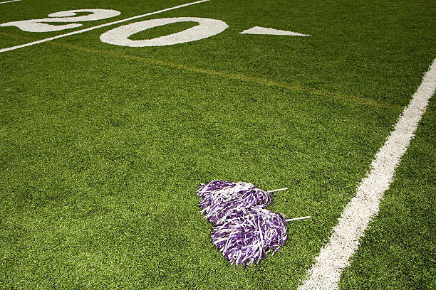 Cheerleading pom-poms on football field